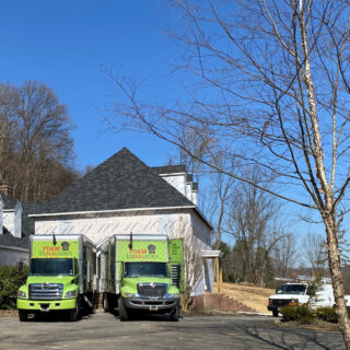 residential spray foam insulation, trucks parked outside house