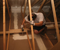 Worker air sealing an attic